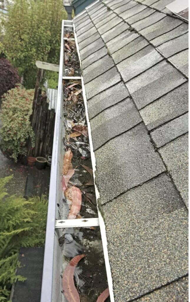 Gutter cleaning with the gutter filled with dirt